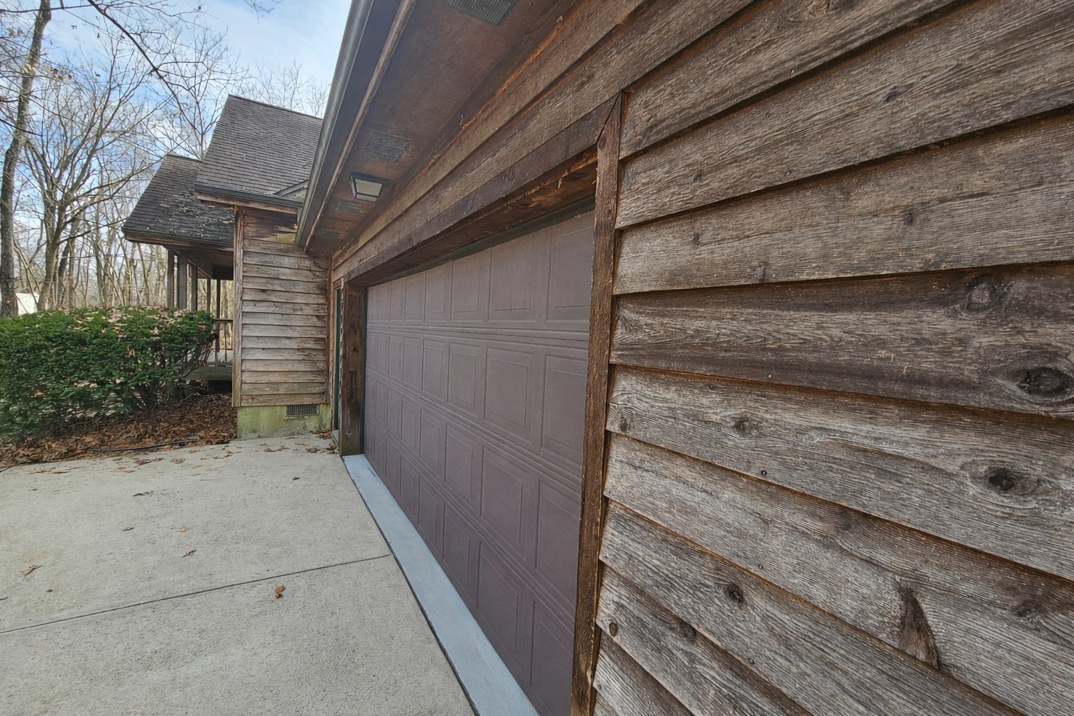 Log home with weathered gray siding before staining — Ozarks MO
