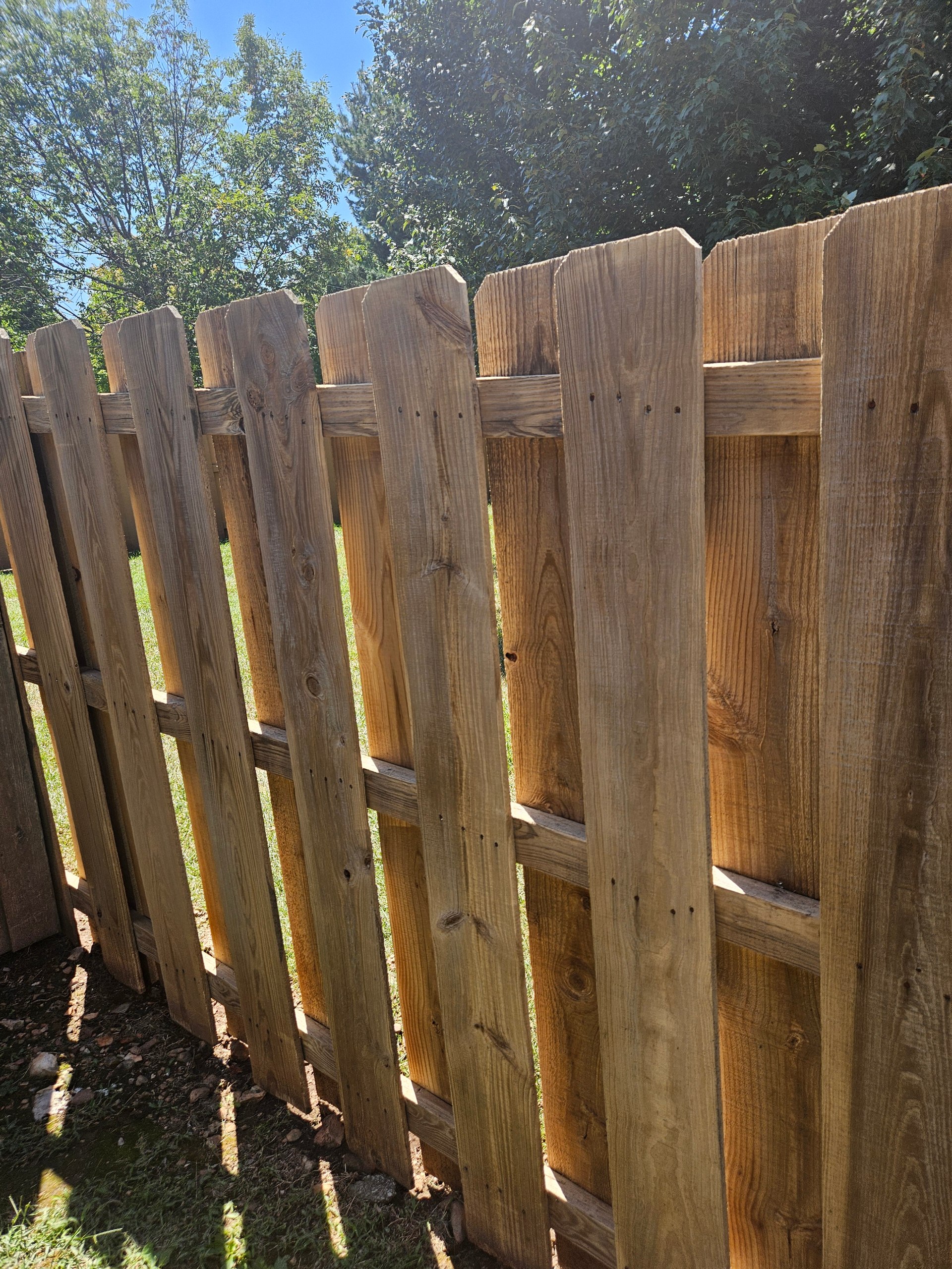 Pine board-on-board fence before Ebony solid stain — Willard MO
